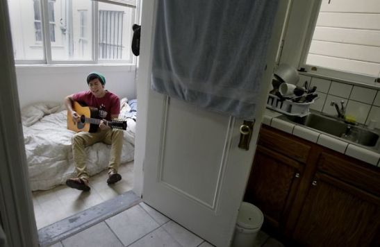 Dan Stifler pays $500 a month for a 7-by-5-foot laundry room off the kitchen in a Mission District flat.   Photo: Brant Ward, The Chronicle